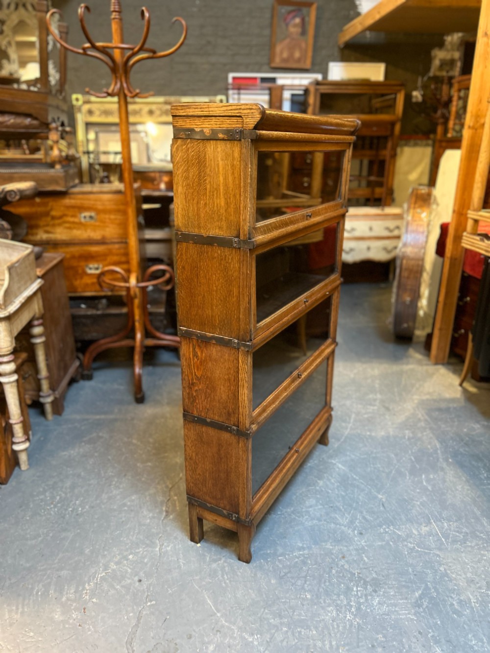 A four-tier oak Globe Wernicke stacking barrister bookcase with glazed up-and-over doors. View X