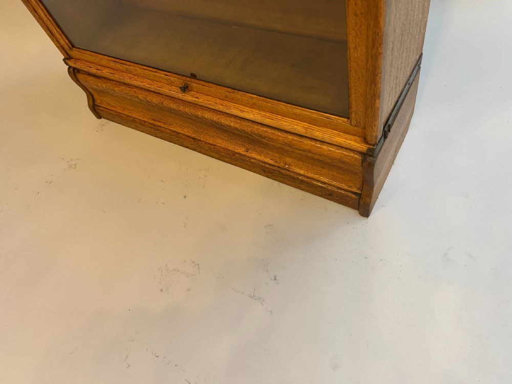 A five-tier antique golden oak Globe Wernicke stacking bookcase with glazed door fronts and side metal bands. View III
