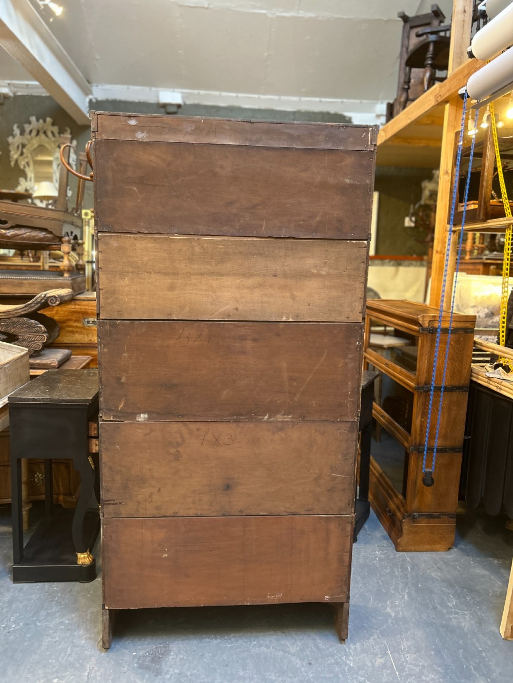 A five-tier antique golden oak Globe Wernicke stacking bookcase with glazed door fronts and side metal bands. View X