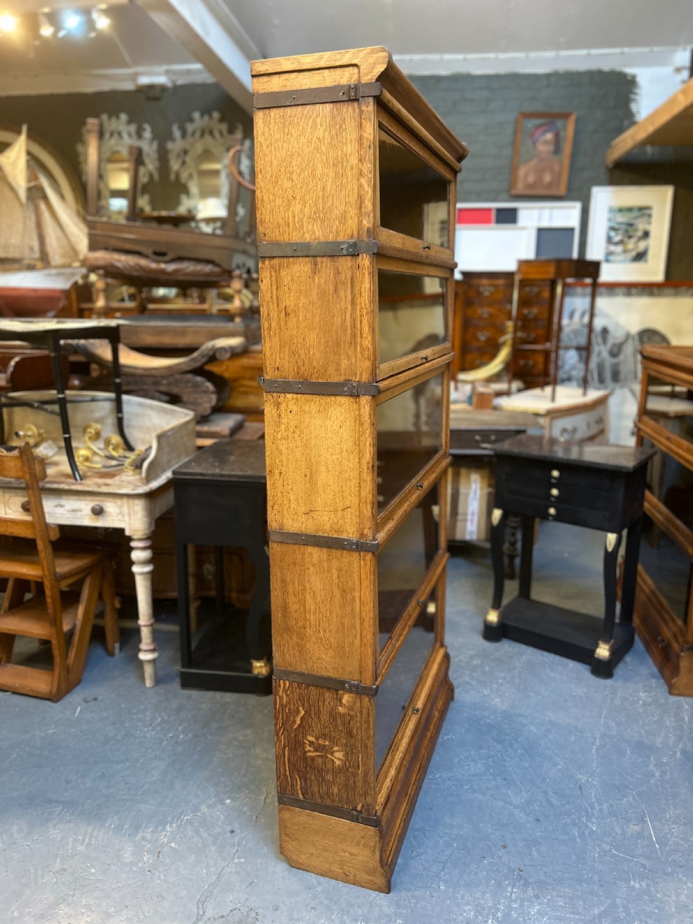 A five-tier antique golden oak Globe Wernicke stacking bookcase with glazed door fronts and side metal bands. View XI