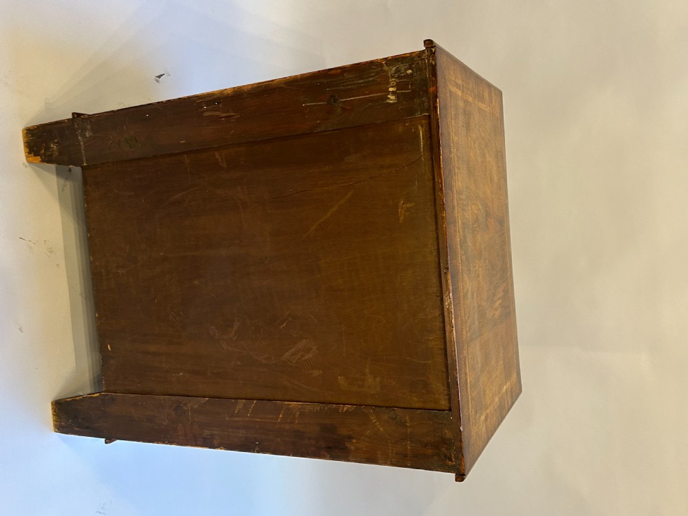 A Georgian Revival walnut bachelors chest featuring four drawers with brass drop handles, a brushing slide, and bracket feet. View IX