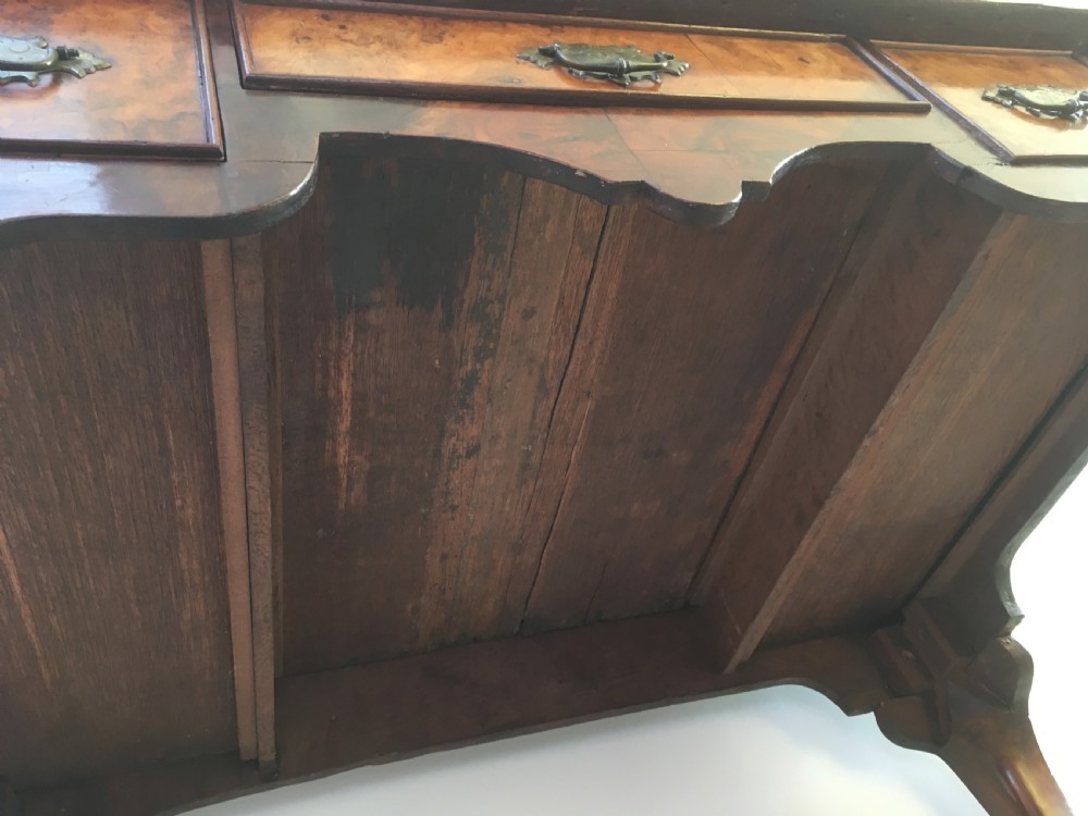 An eighteenth-century George II burr walnut lowboy featuring three drawers, brass handles, a shaped apron, and four slender cabriole legs. View XII