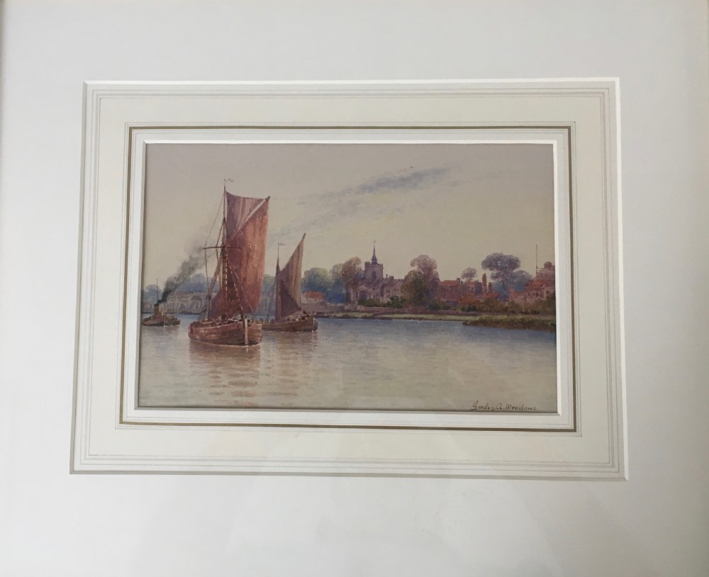 A pair of horizontally framed watercolour paintings depicting Thames sailing barges on calm water, enclosed in matching gilt frames with double mounts. View II