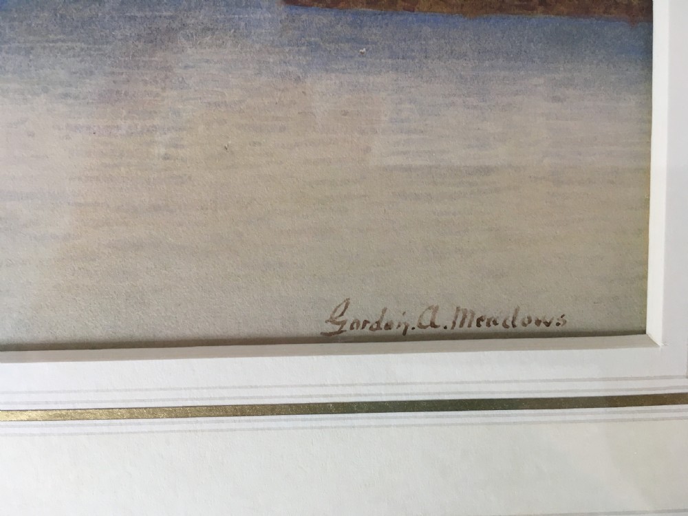 A pair of horizontally framed watercolour paintings depicting Thames sailing barges on calm water, enclosed in matching gilt frames with double mounts. View VI