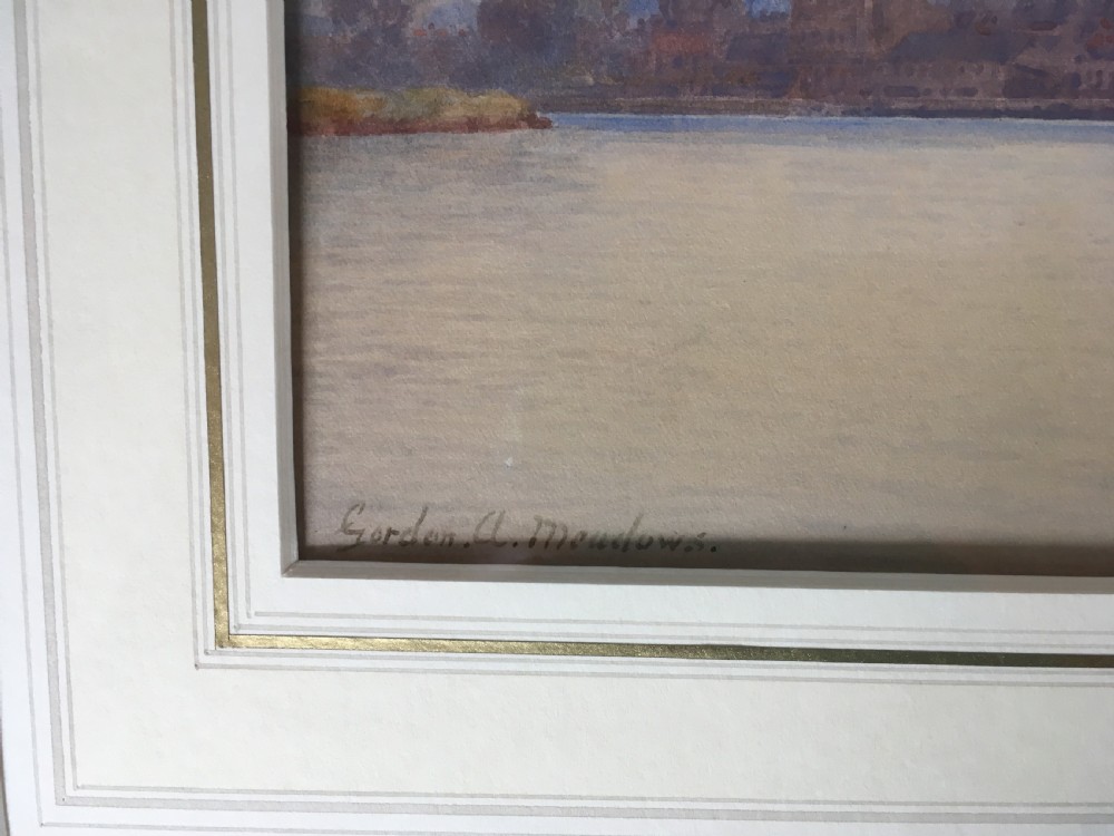 A pair of horizontally framed watercolour paintings depicting Thames sailing barges on calm water, enclosed in matching gilt frames with double mounts. View VII