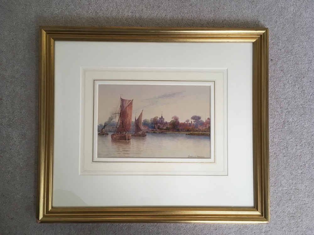 A pair of horizontally framed watercolour paintings depicting Thames sailing barges on calm water, enclosed in matching gilt frames with double mounts. View IX