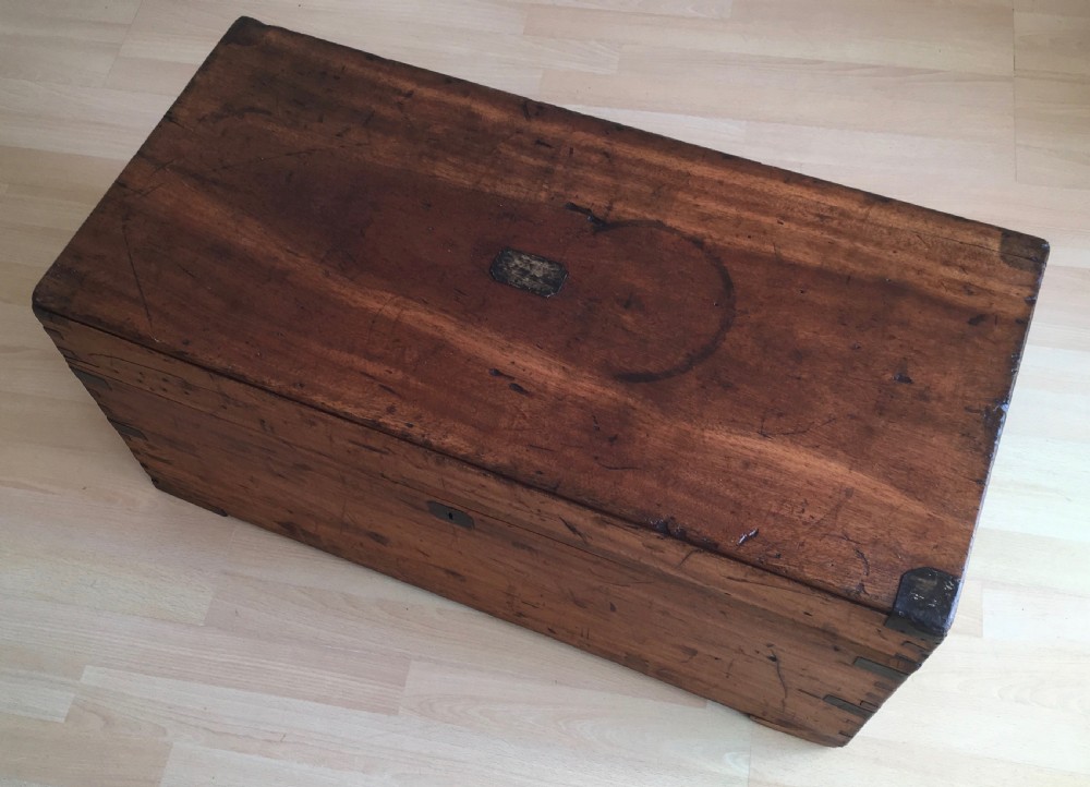 A rectangular Victorian camphor wood storage trunk with dark metal corner brackets and a brass lid plaque.