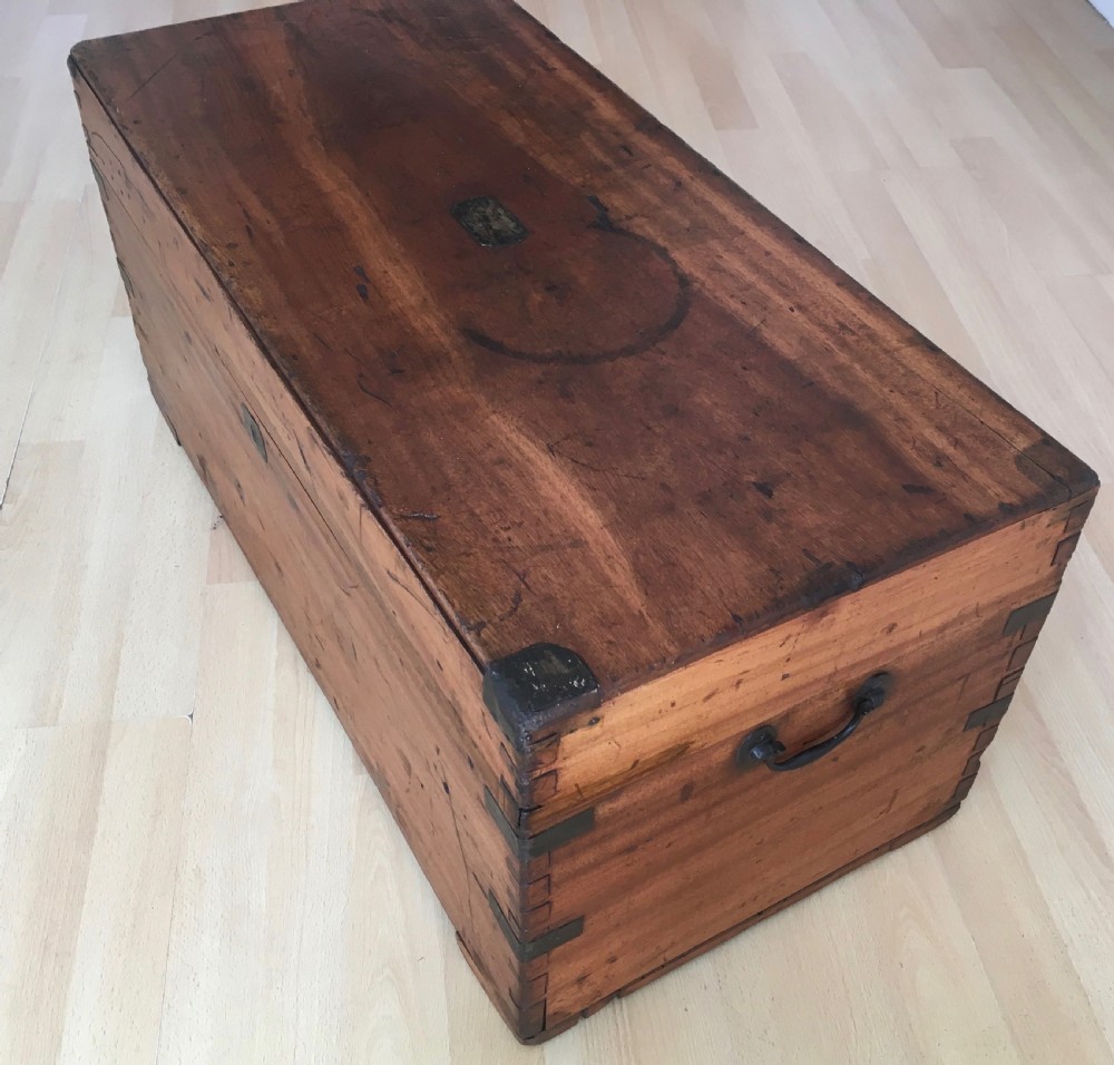 A rectangular Victorian camphor wood storage trunk with dark metal corner brackets and a brass lid plaque. View II