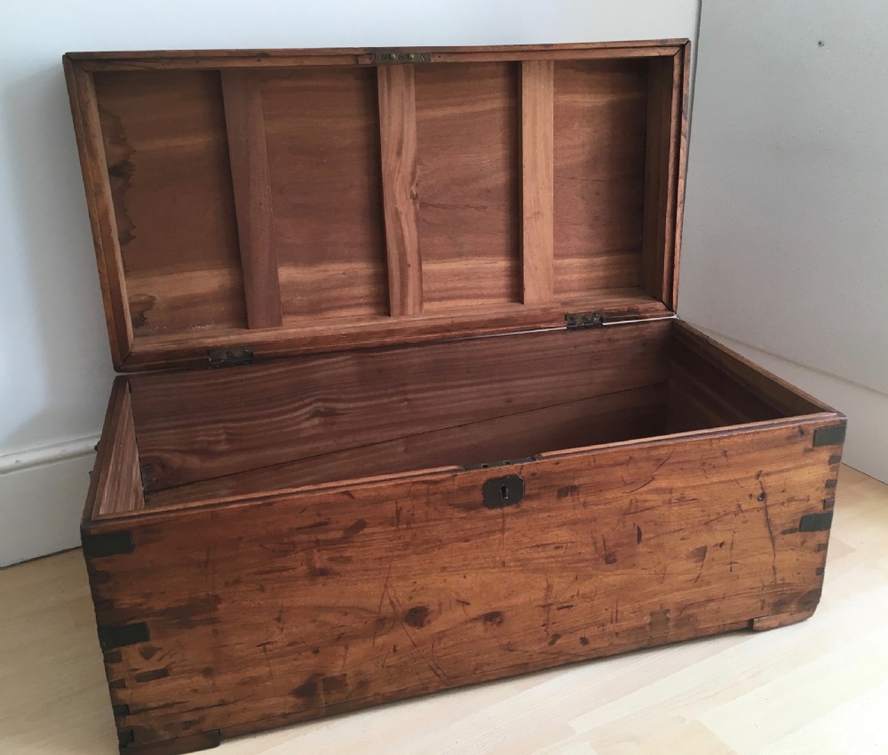 A rectangular Victorian camphor wood storage trunk with dark metal corner brackets and a brass lid plaque. View IV