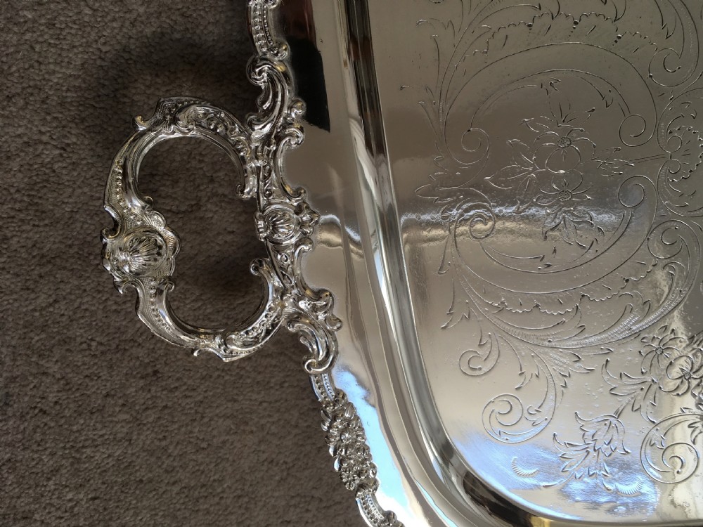 A 19th-century rectangular silver-plated serving tray featuring engraved foliate scrollwork, a decorative rim, and two cast side handles. View II