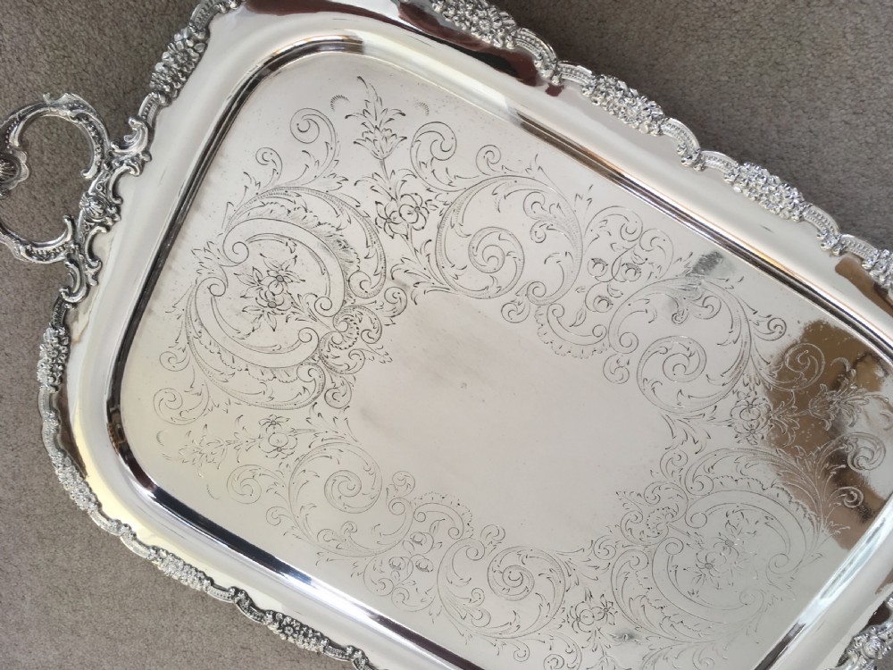 A 19th-century rectangular silver-plated serving tray featuring engraved foliate scrollwork, a decorative rim, and two cast side handles. View IV