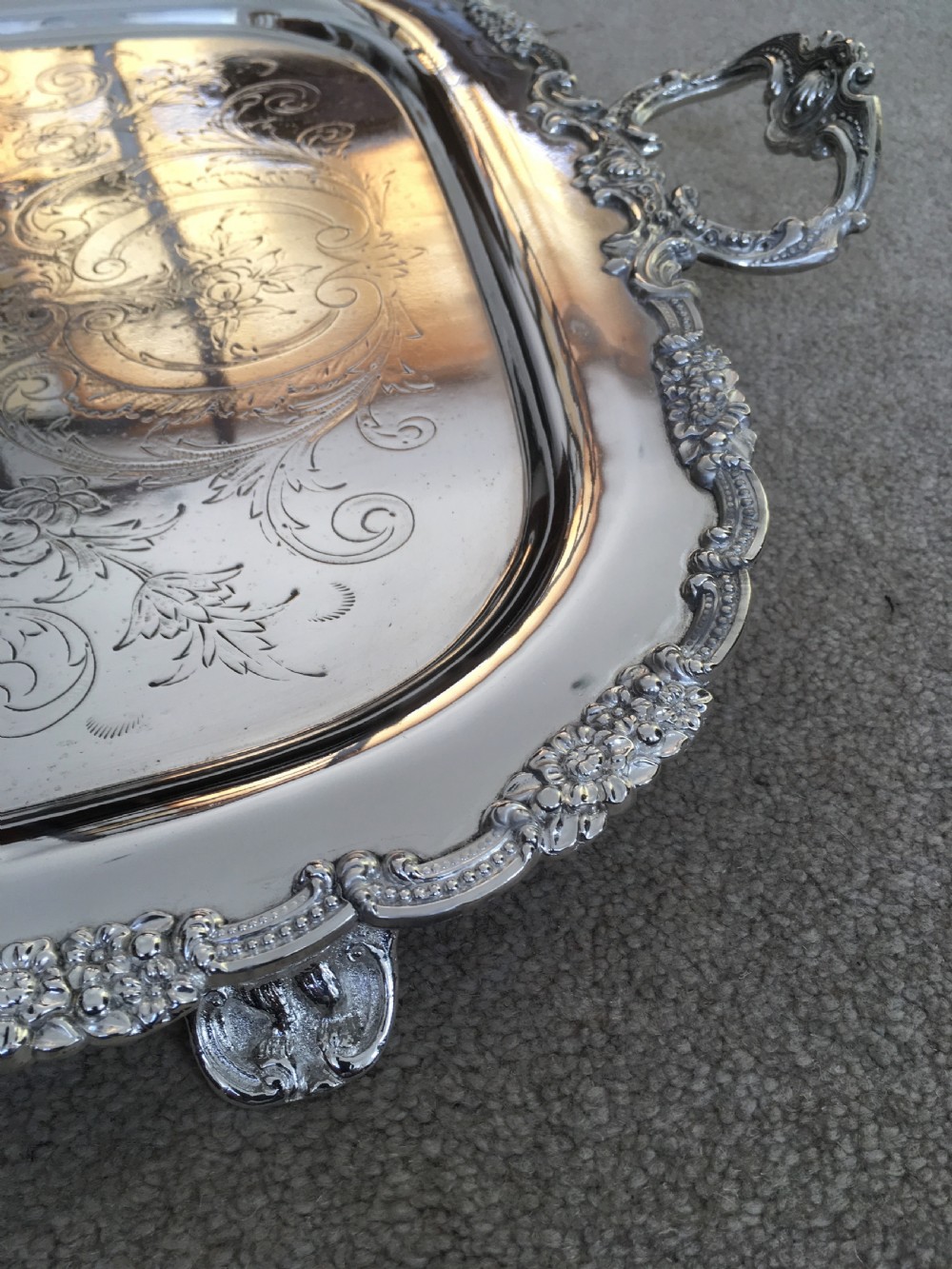 A 19th-century rectangular silver-plated serving tray featuring engraved foliate scrollwork, a decorative rim, and two cast side handles. View VI