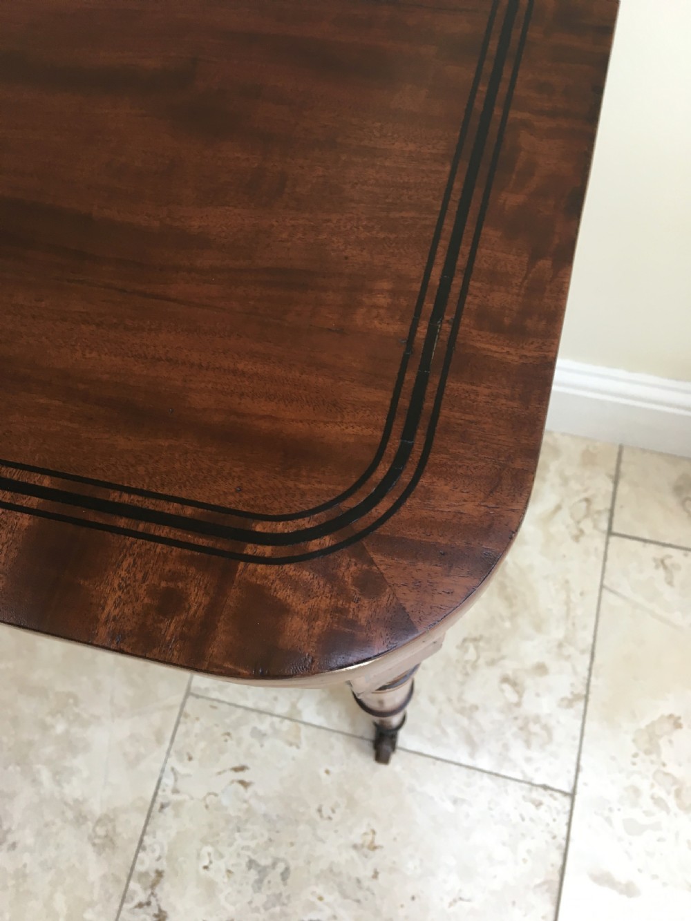 A Regency mahogany fold-over card table featuring turned tapered legs, brass castors, and boxwood stringing inlay along the frieze. View VIII