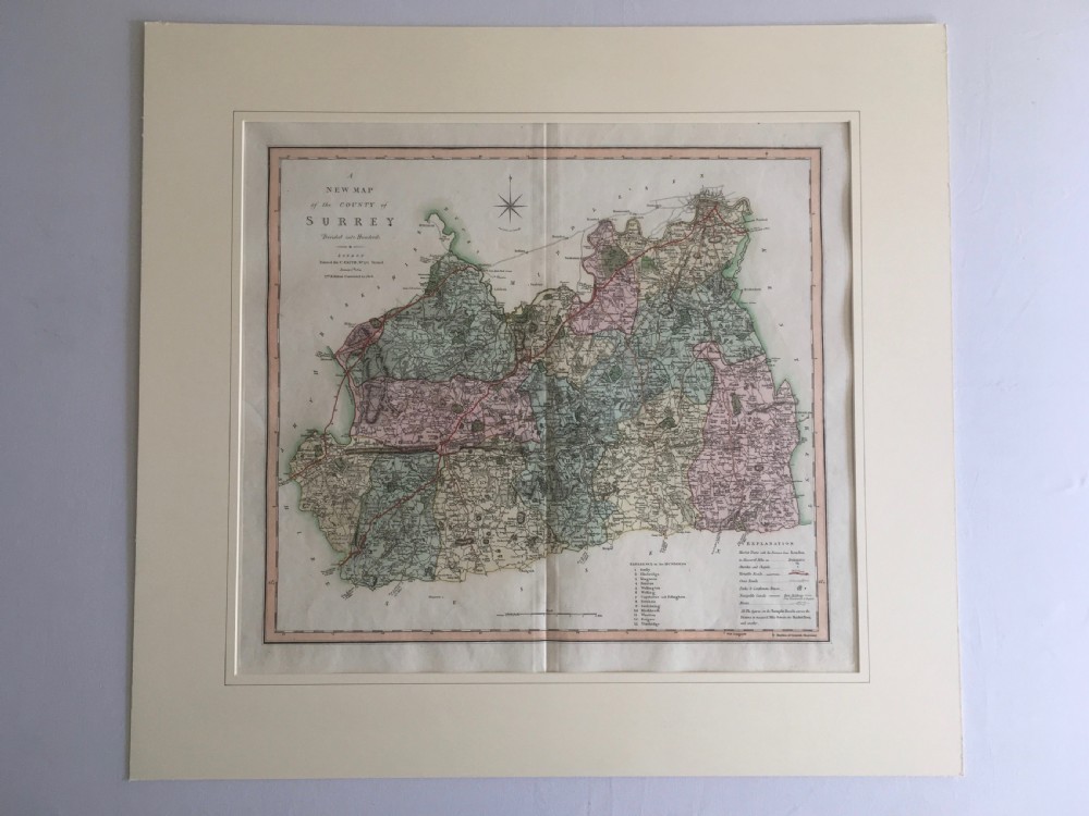 An engraved 1808 hand-coloured map of Surrey by C. Smith, mounted within a broad cream mat board.