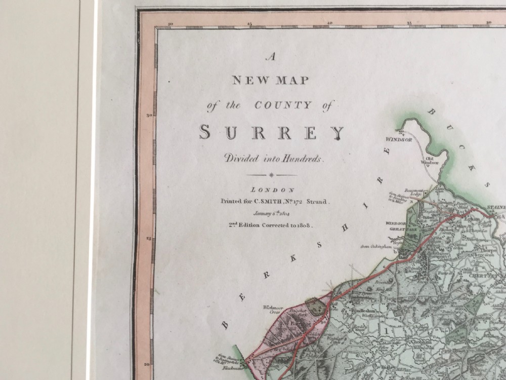 An engraved 1808 hand-coloured map of Surrey by C. Smith, mounted within a broad cream mat board. View II