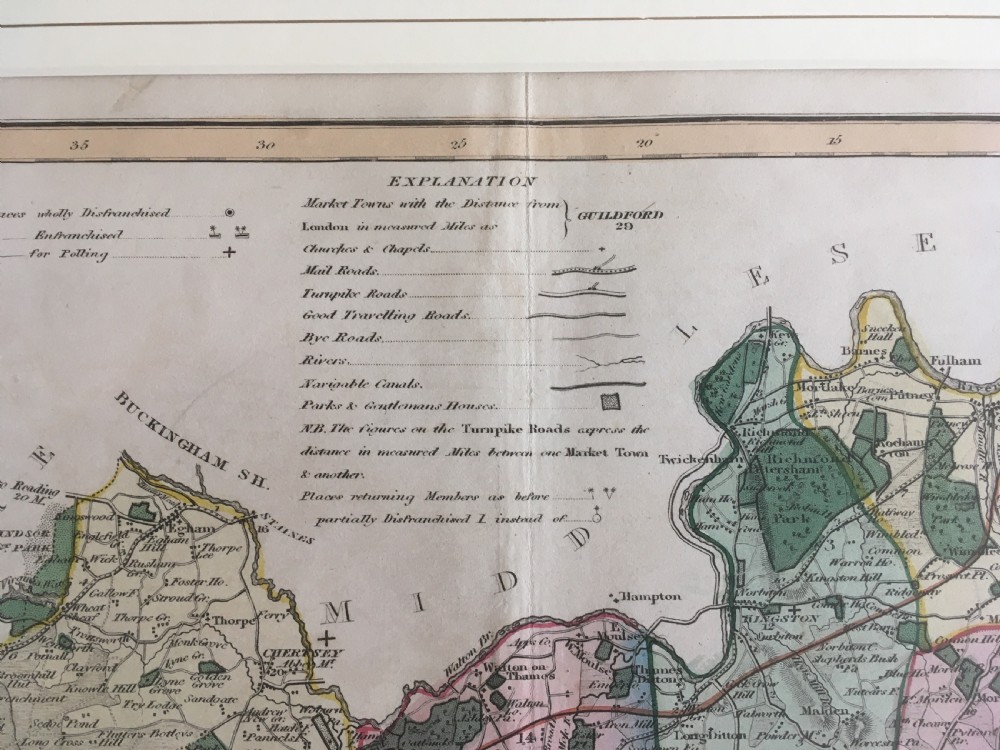 An 1833 hand-coloured engraved map of the county of Surrey by J. Duncan mounted in an off-white mat. View III