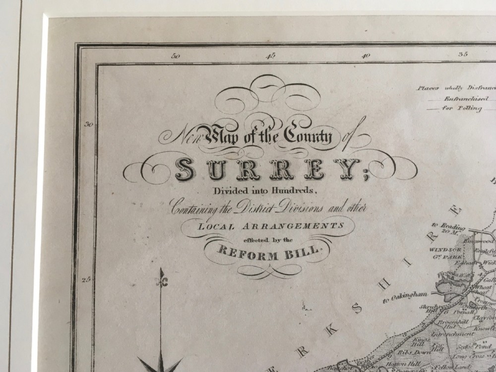An 1833 hand-coloured engraved map of the county of Surrey by J. Duncan mounted in an off-white mat. View VII