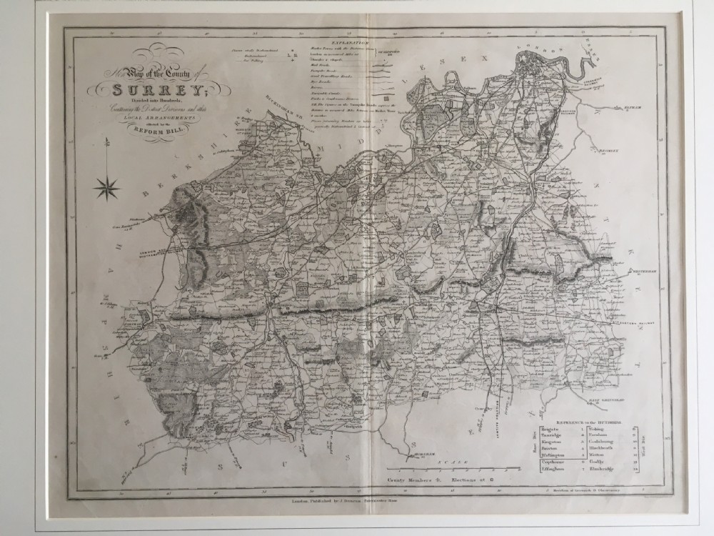 An 1833 hand-coloured engraved map of the county of Surrey by J. Duncan mounted in an off-white mat. View XI
