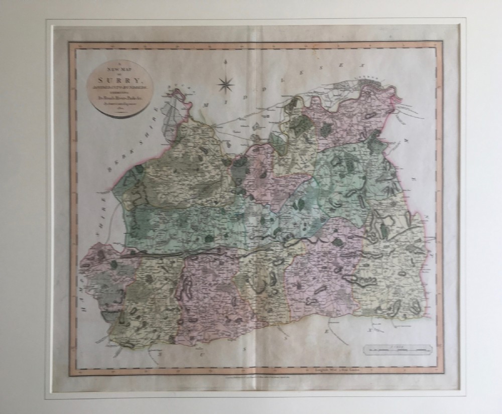 An antique hand-coloured engraved map of Surrey by John Cary, dated 1801, presented on a cream mount with an oval title cartouche. View IV