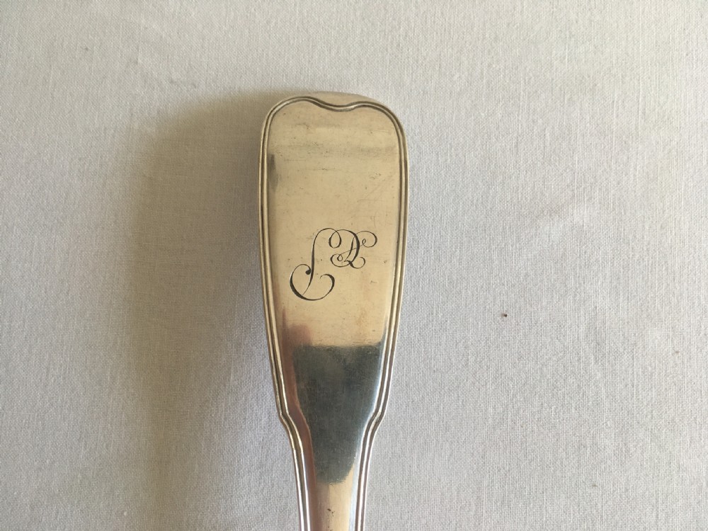 An antique silver soup or punch ladle featuring a deep gilt-washed bowl and a contoured handle. View II