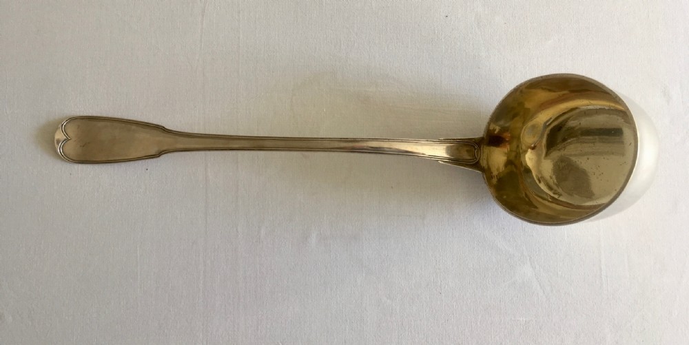 An antique silver soup or punch ladle featuring a deep gilt-washed bowl and a contoured handle. View VII