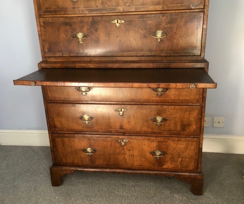 An 18th-century George II walnut tallboy chest-on-chest featuring figured veneer drawers, brass drop handles, and bracket feet. View VIII