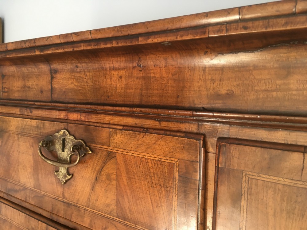 An 18th-century George II walnut tallboy chest-on-chest featuring figured veneer drawers, brass drop handles, and bracket feet. View XI