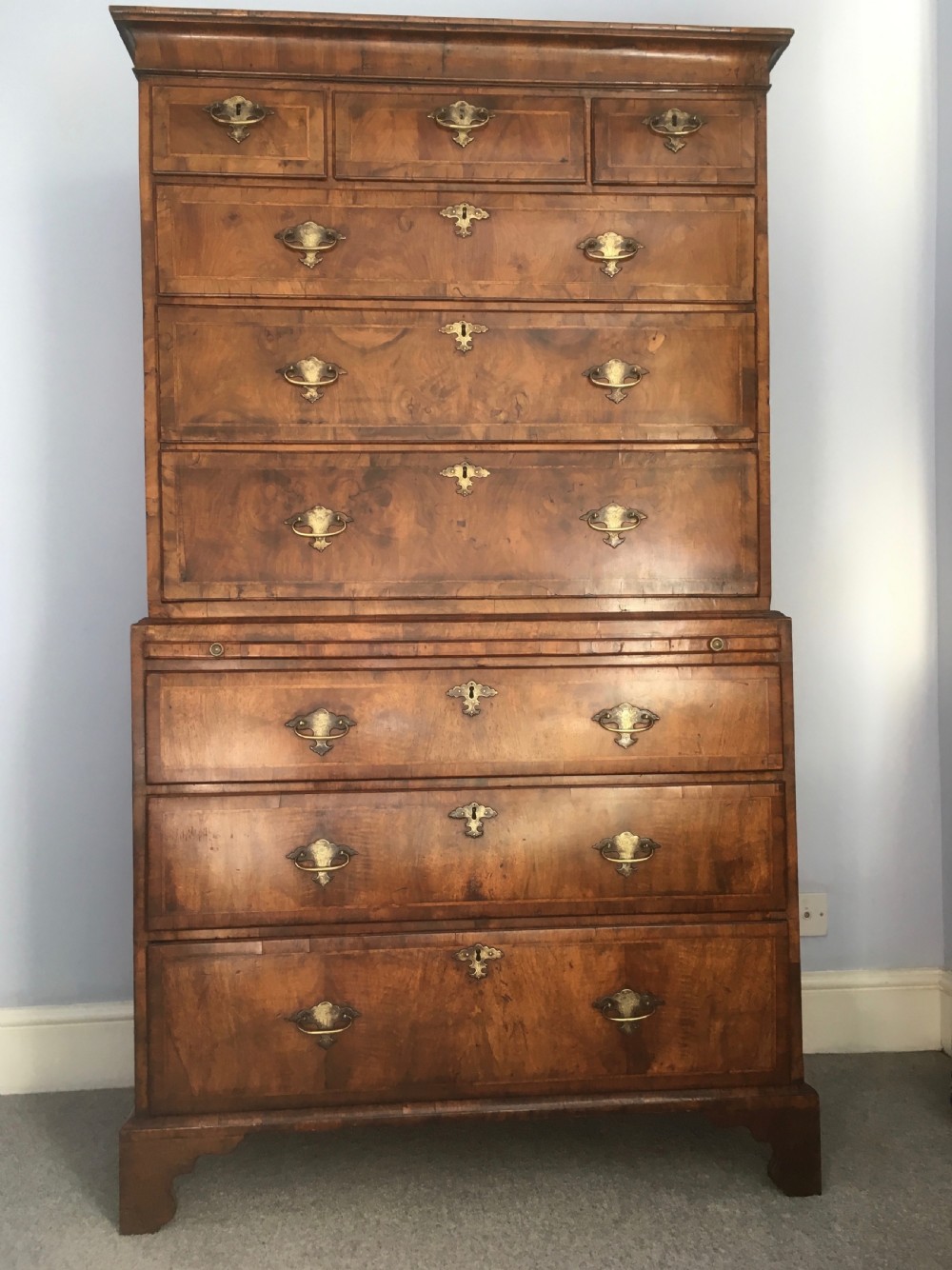 An 18th-century George II walnut tallboy chest-on-chest featuring figured veneer drawers, brass drop handles, and bracket feet. View XIII