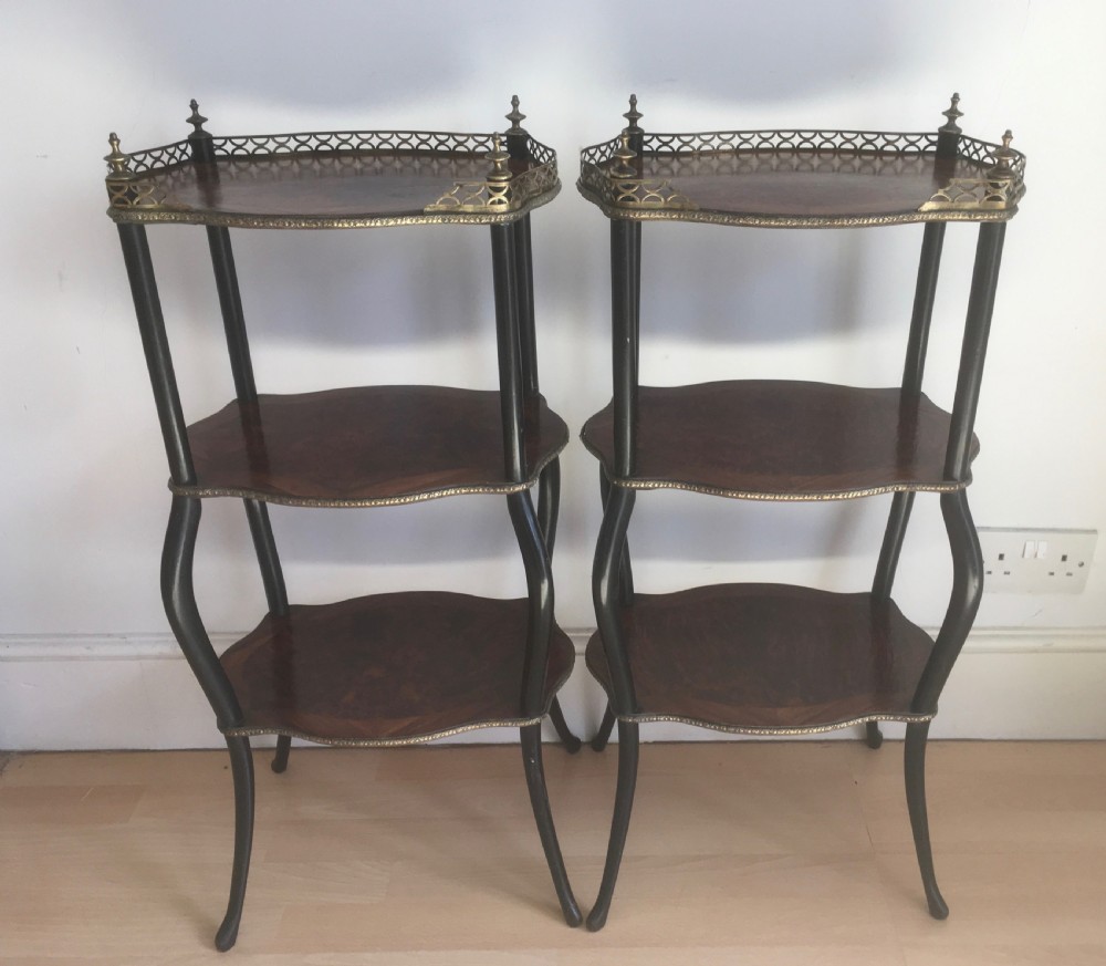 A pair of three-tiered French style side tables crafted from dark wood with inlaid marquetry work, gilt metal gallery rails, and cabriole legs. View II