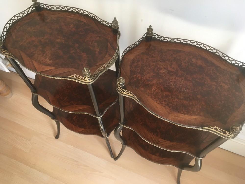 A pair of three-tiered French style side tables crafted from dark wood with inlaid marquetry work, gilt metal gallery rails, and cabriole legs. View III