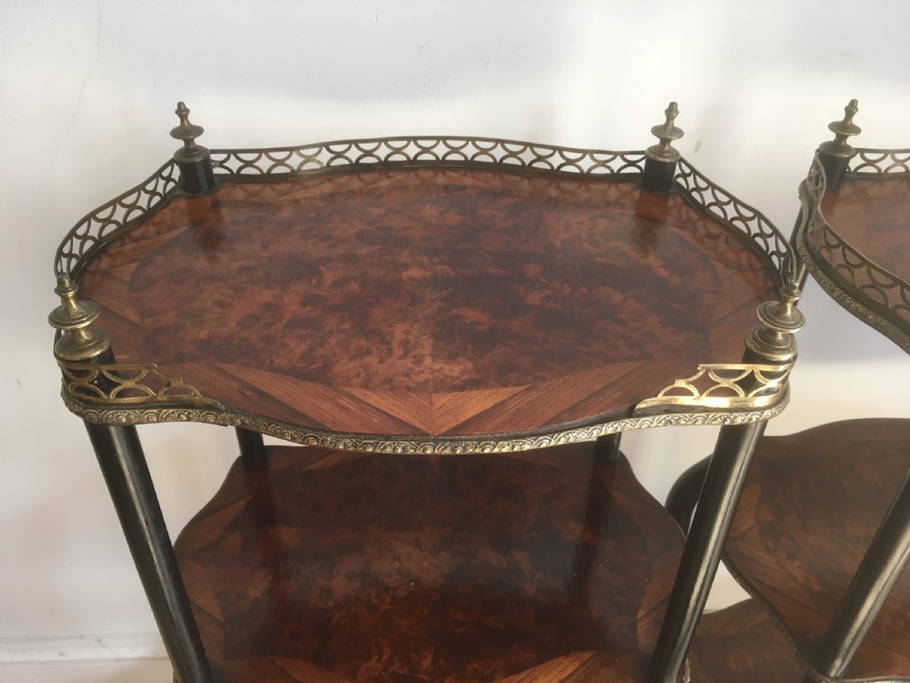 A pair of three-tiered French style side tables crafted from dark wood with inlaid marquetry work, gilt metal gallery rails, and cabriole legs. View XIII