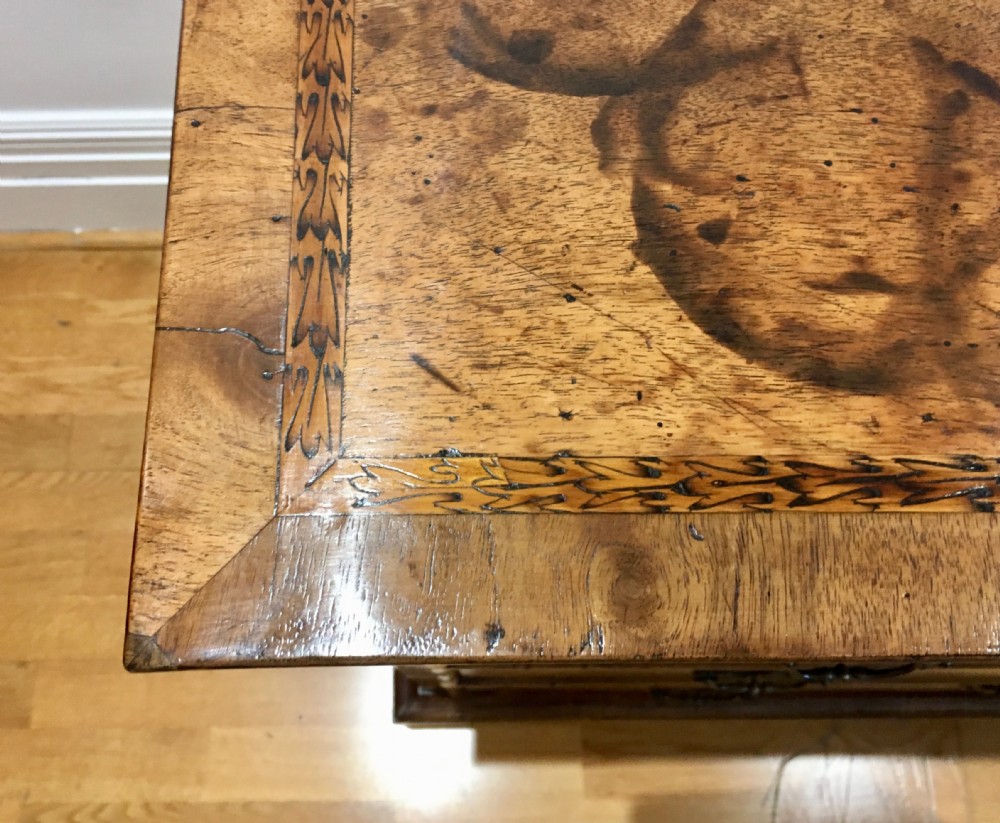 An eighteenth-century walnut chest of drawers featuring decorative poker work inlay, brass swing handles, keyhole escutcheons, and straight bracket feet. View IX