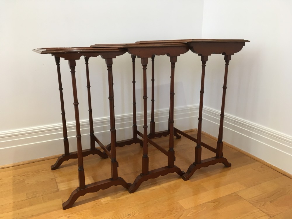 A set of three nested wooden side tables featuring rectangular tops with oval amboyna wood centres, inlaid satinwood borders, and slender turned legs. View VIII
