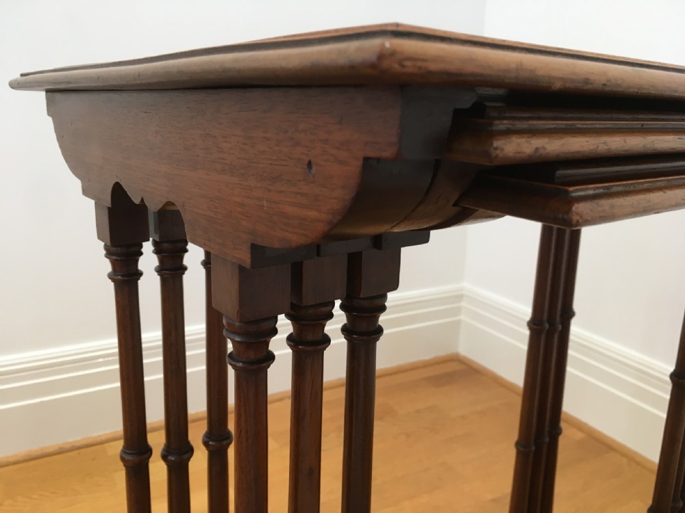 A set of three nested wooden side tables featuring rectangular tops with oval amboyna wood centres, inlaid satinwood borders, and slender turned legs. View XV