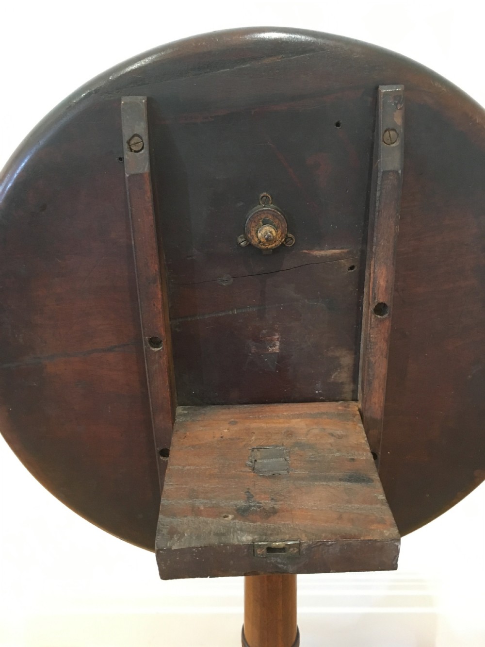 A Georgian dark mahogany tilt-top occasional table featuring a circular dished top supported by a turned central pedestal column and a tripod base with downswept legs. View XIV