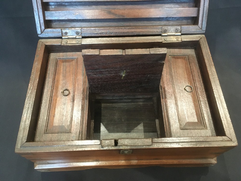 A rectangular warm brown oak desk box featuring brass bound corners, metal straps, a central brass oval cartouche, and a front keyhole escutcheon. View IX