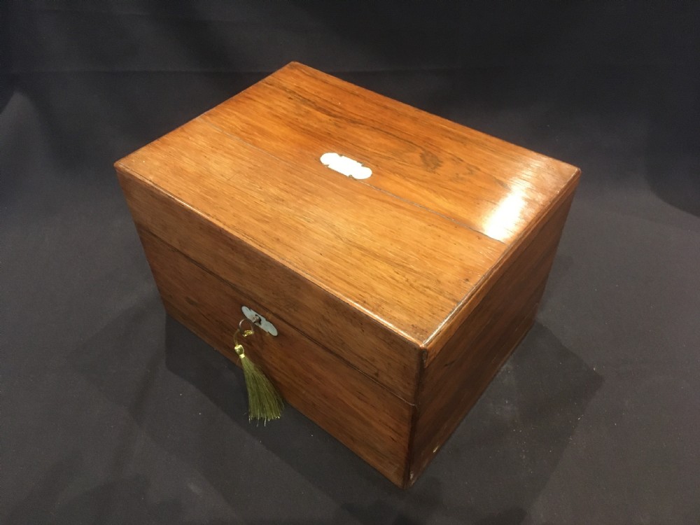 An open rosewood vanity box lined with vibrant blue velvet, containing cut glass jars, silver-plated lids, and manicure tools. View XI