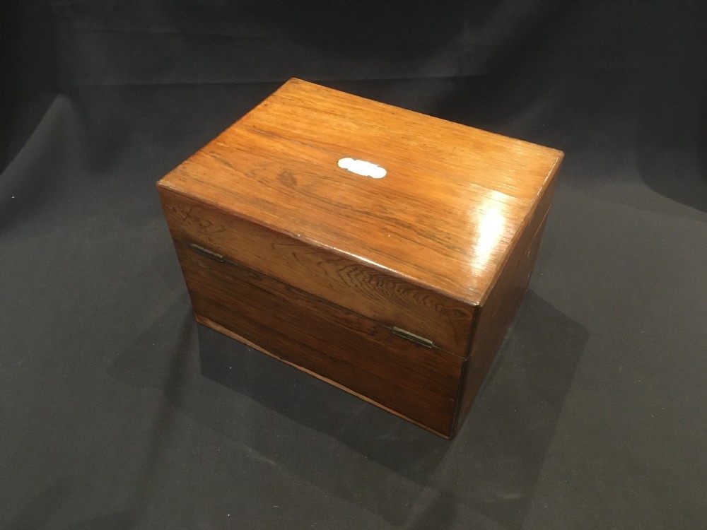 An open rosewood vanity box lined with vibrant blue velvet, containing cut glass jars, silver-plated lids, and manicure tools. View XIII