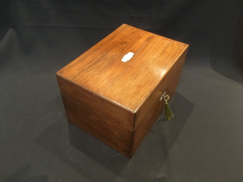 An open rosewood vanity box lined with vibrant blue velvet, containing cut glass jars, silver-plated lids, and manicure tools. View XIV