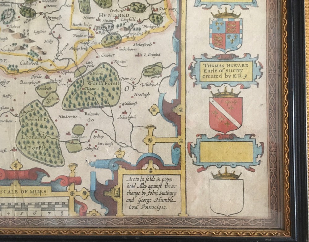 A framed historical map of Surrey by John Speed, displaying administrative divisions, coats of arms, and detailed corner insets of Richmond and Nonsuch palaces. View VIII