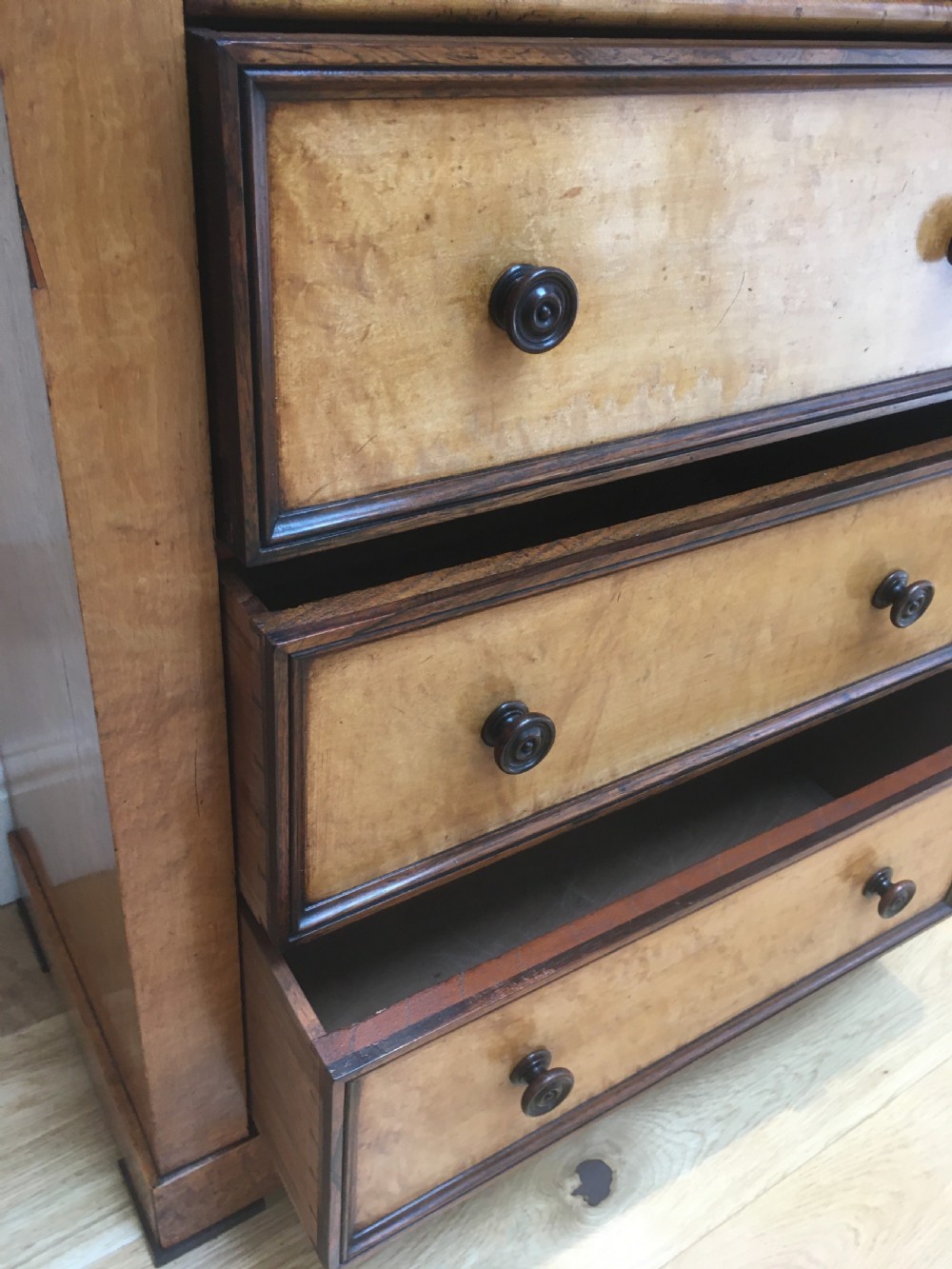 A tall Victorian birdseye maple secretaire Wellington chest featuring a hinged side locking bar, rosewood crossbanding, and a drop-down writing drawer revealing internal compartments. View XII