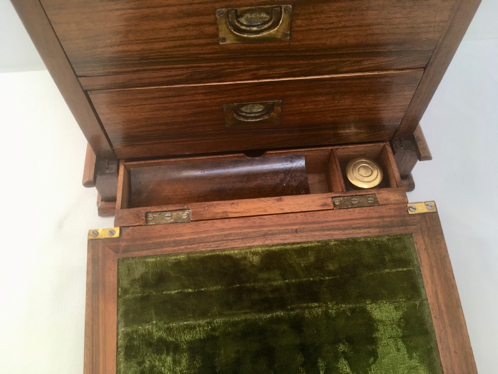An inlaid walnut correspondence chest featuring geometric band inlay around figured wood panels, a domed lid, two front doors, and a central keyhole with a key inserted. View VI