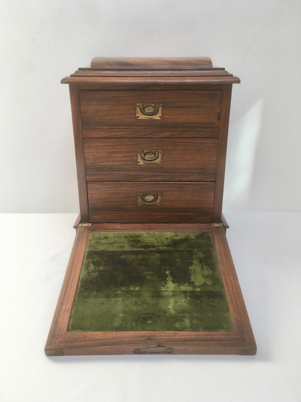 An inlaid walnut correspondence chest featuring geometric band inlay around figured wood panels, a domed lid, two front doors, and a central keyhole with a key inserted. View XIII
