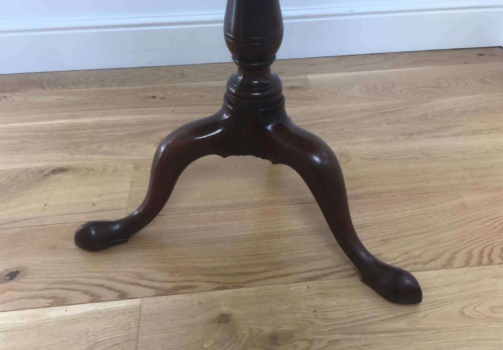 A Georgian mahogany tilt top table featuring a circular top, turned central pedestal, and tripod cabriole legs. View II