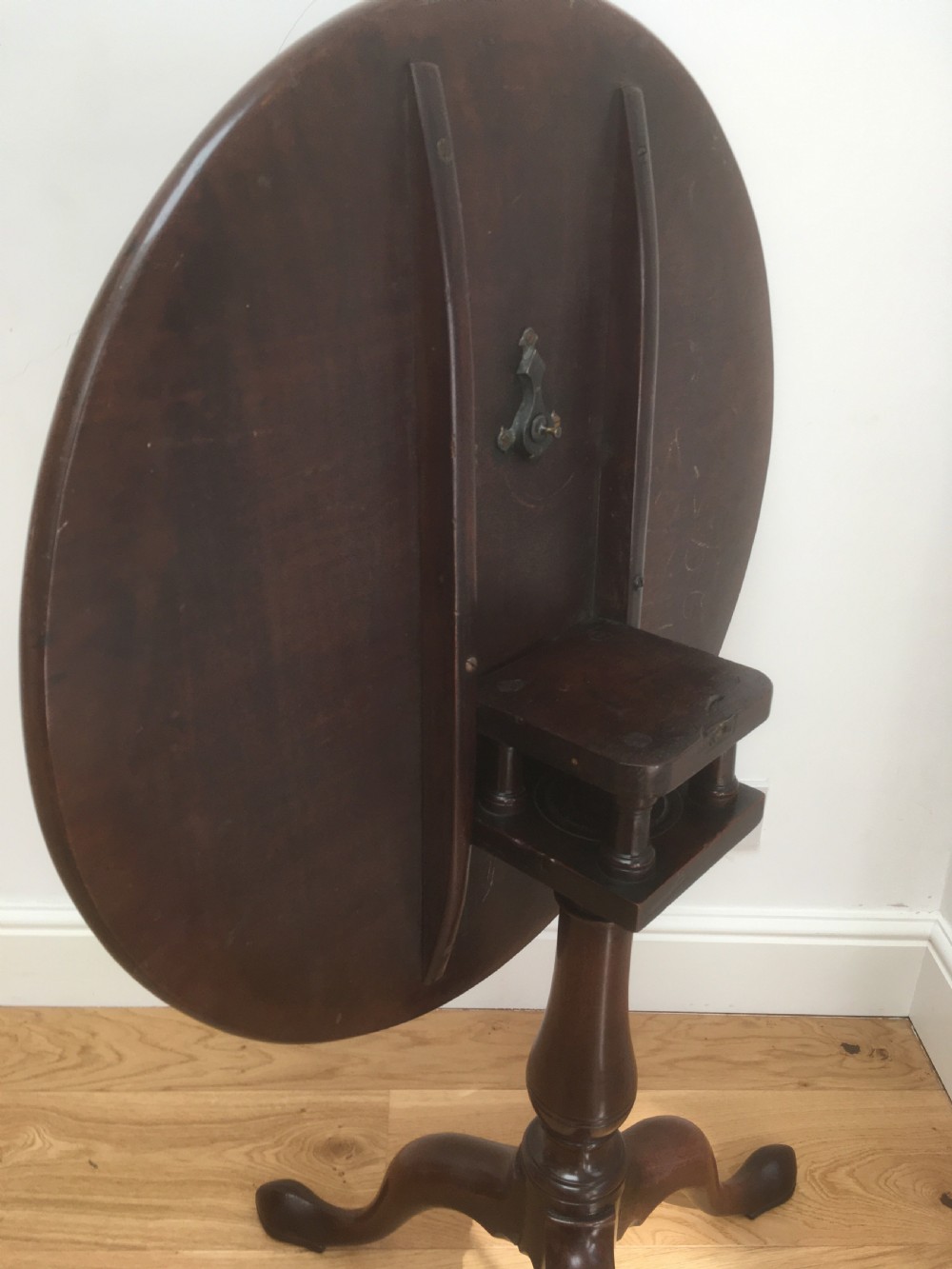 A Georgian mahogany tilt top table featuring a circular top, turned central pedestal, and tripod cabriole legs. View XI