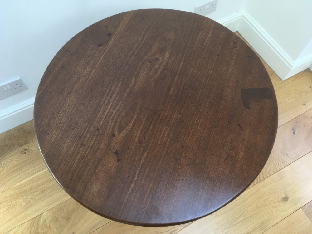 A Georgian mahogany tilt top table featuring a circular top, turned central pedestal, and tripod cabriole legs. View XIII