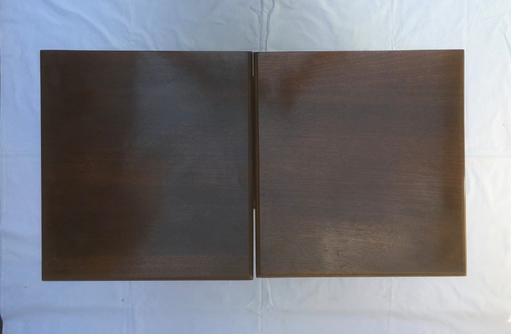 A matching pair of slim Edwardian mahogany bedside cabinets featuring carved swag decoration, single cupboards, brass handles, and solid plinth bases. View XV