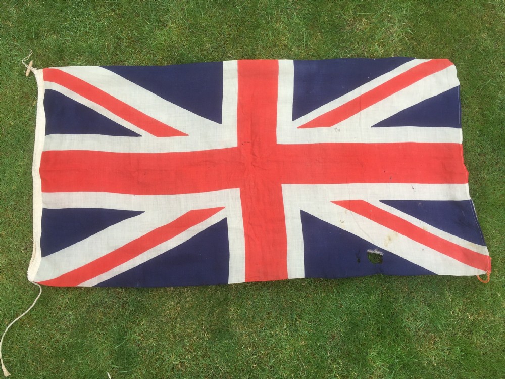 A rectangular Second World War Royal Navy White Ensign flag featuring a white field with a red Saint Georges Cross, a Union Jack canton, and a stitched canvas edge with rope lanyard. View VIII