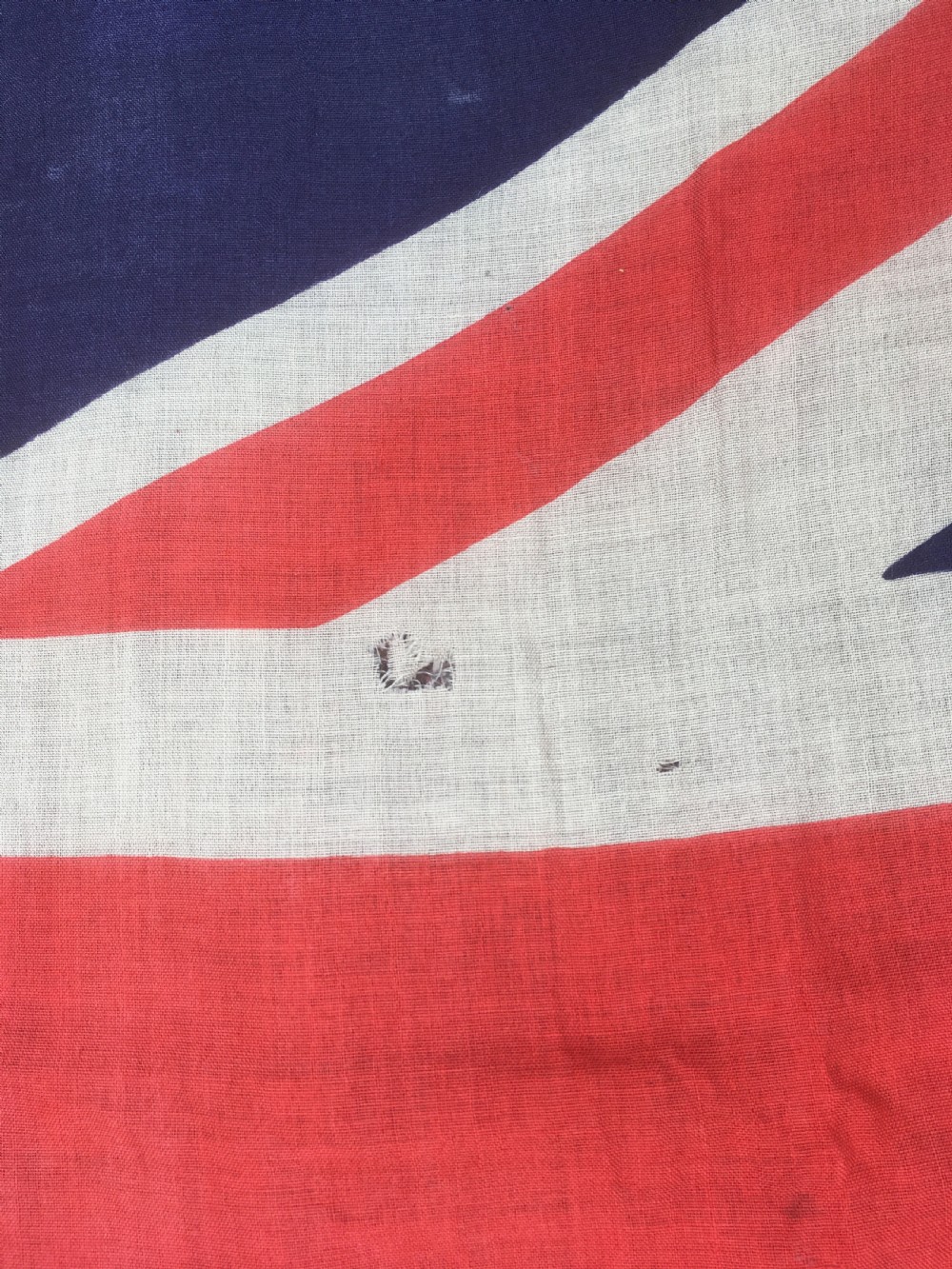 A rectangular Second World War Royal Navy White Ensign flag featuring a white field with a red Saint Georges Cross, a Union Jack canton, and a stitched canvas edge with rope lanyard. View XI