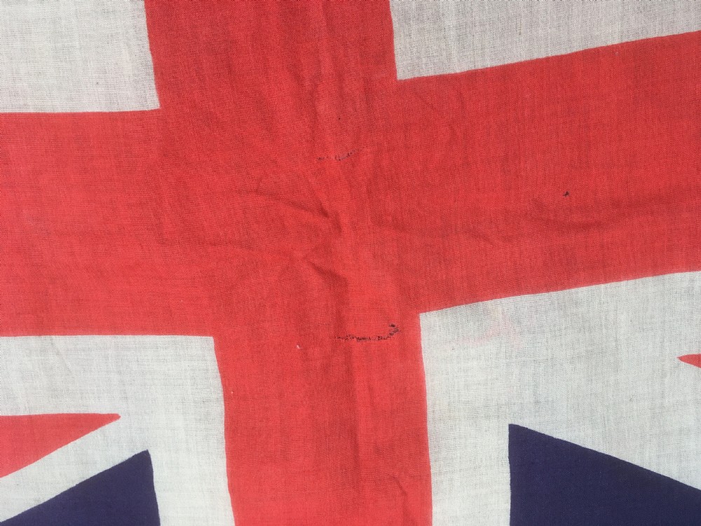 A rectangular Second World War Royal Navy White Ensign flag featuring a white field with a red Saint Georges Cross, a Union Jack canton, and a stitched canvas edge with rope lanyard. View XIV